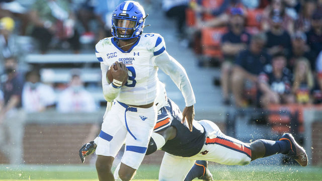 AUBURN, ALABAMA - SEPTEMBER 25: Quarterback Darren Grainger #3 of the Georgia State Panthers runs the ball by defensive end T.D. Moultry #99 of the Auburn Tigers at Jordan-Hare Stadium on September 25, 2021 in Auburn, Alabama.