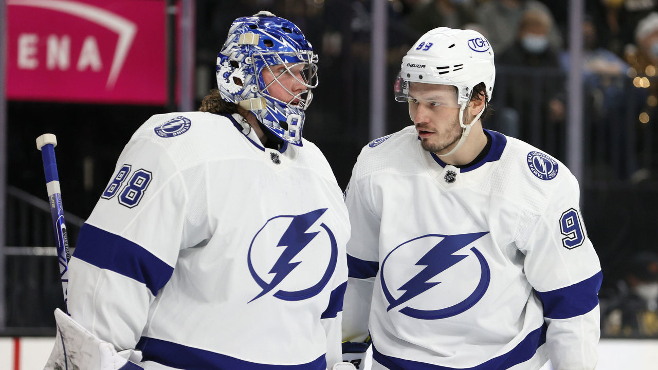 LAS VEGAS, NEVADA - DECEMBER 21: Andrei Vasilevskiy #88 an Mikhail Sergachev #98 of the Tampa Bay Lightning talk during a stop in play in the second period of a game against the Vegas Golden Knights at T-Mobile Arena on December 21, 2021 in Las Vegas, Nevada. The Lightning defeated the Golden Knights 4-3.