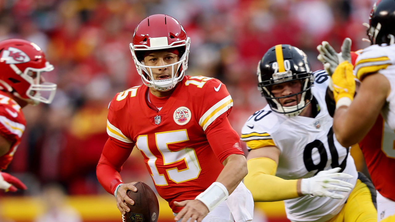 KANSAS CITY, MISSOURI - DECEMBER 26: Patrick Mahomes #15 of the Kansas City Chiefs is chased by T.J. Watt #90 and Alex Highsmith #56 of the Pittsburgh Steelers during the second quarter at Arrowhead Stadium on December 26, 2021 in Kansas City, Missouri.