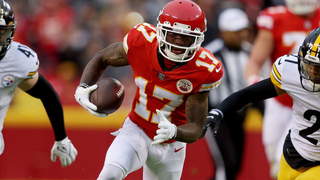 KANSAS CITY, MISSOURI - DECEMBER 26: Mecole Hardman #17 of the Kansas City Chiefs runs with the ball after a catch while being chased by Tre Norwood #21 and Robert Spillane #41 of the Pittsburgh Steelers during the second quarter at Arrowhead Stadium on December 26, 2021 in Kansas City, Missouri.