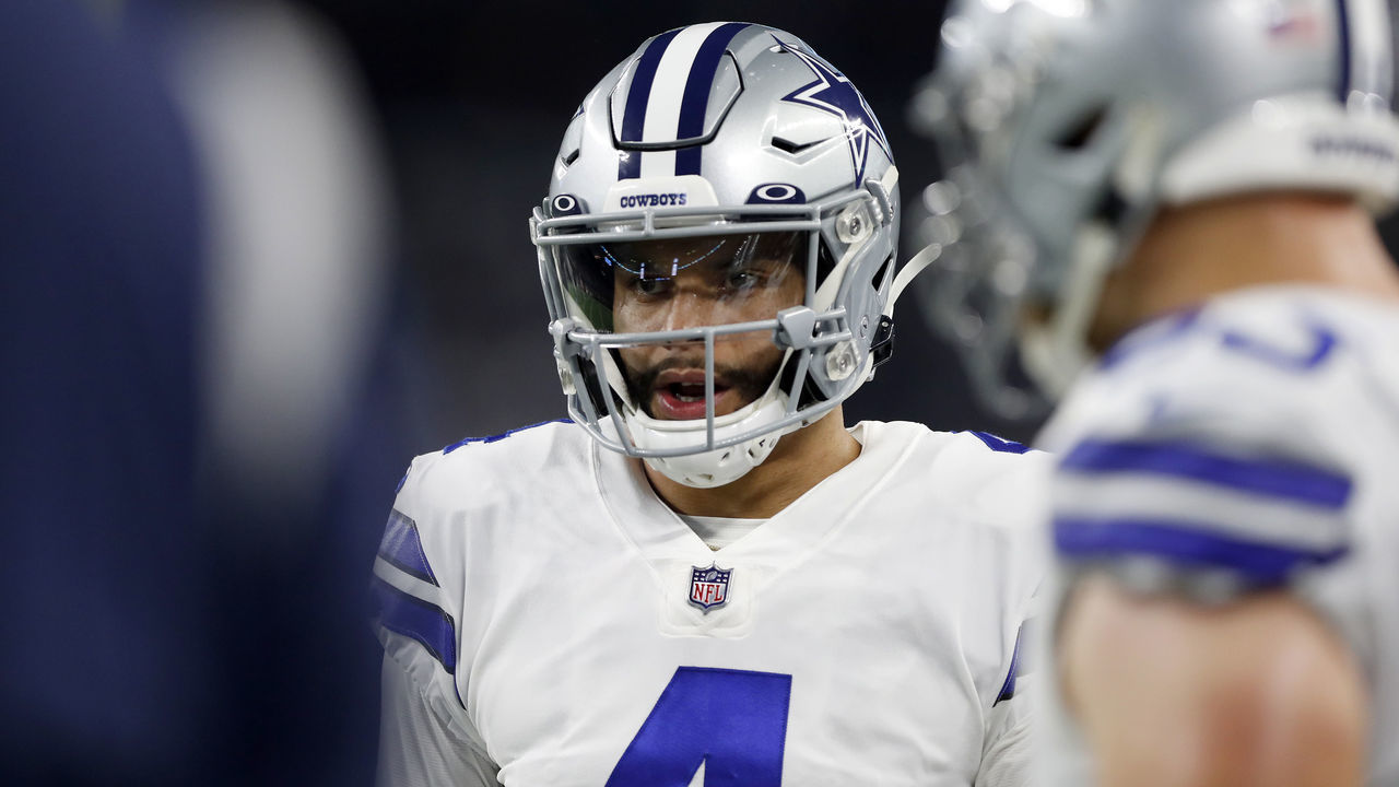 ARLINGTON, TEXAS - DECEMBER 26: Dak Prescott #4 of the Dallas Cowboys looks on during the first quarter against the Washington Football Team at AT&T Stadium on December 26, 2021 in Arlington, Texas.