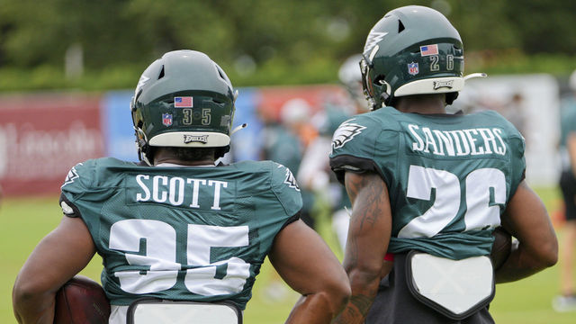 PHILADELPHIA, PA - AUGUST 03: Philadelphia Eagles running back Boston Scott (35) and Philadelphia Eagles running back Miles Sanders (26) look on during the Philadelphia Eagles training camp on August 03, 2021 at NovaCare Training Complex in Philadelphia ,PA.