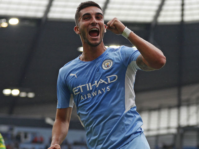 Manchester City's Spanish midfielder Ferran Torres celebrates after scoring but after a VAR (Video Assistant Referee) review it is disallowed during the English Premier League football match between Manchester City and Norwich City at the Etihad Stadium in Manchester, north west England, on August 21, 2021. - RESTRICTED TO EDITORIAL USE. No use with unauthorized audio, video, data, fixture lists, club/league logos or 'live' services. Online in-match use limited to 120 images. An additional 40 images may be used in extra time. No video emulation. Social media in-match use limited to 120 images. An additional 40 images may be used in extra time. No use in betting publications, games or single club/league/player publications.