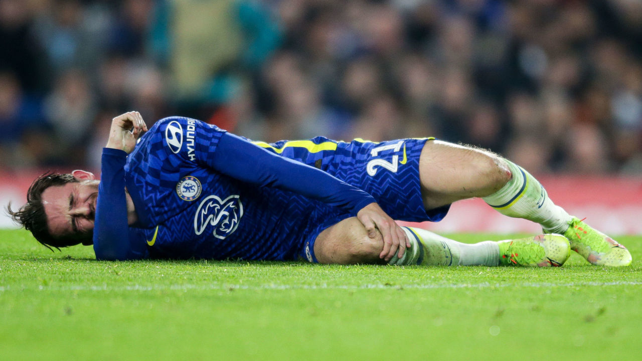 LONDON, ENGLAND - NOVEMBER 23: Ben Chilwell of Chelsea goes down injured before he is replaced during the UEFA Champions League group H match between Chelsea FC and Juventus at Stamford Bridge on November 23, 2021 in London, England.