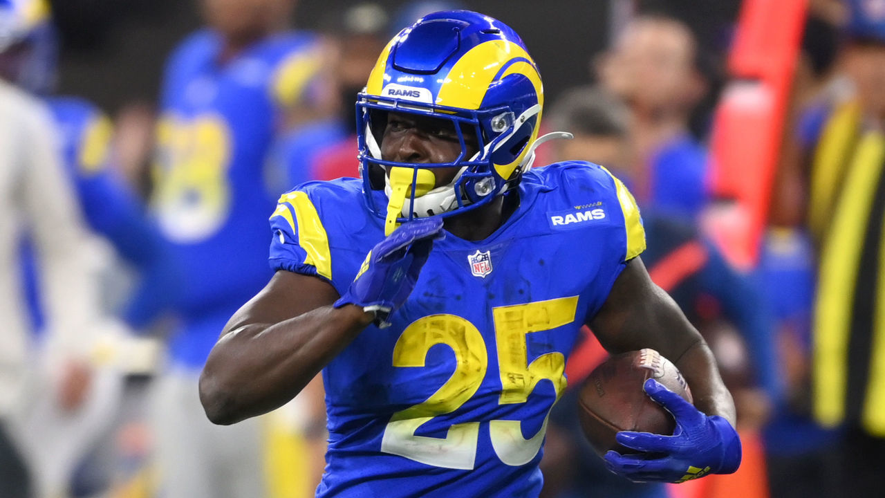INGLEWOOD, CA - DECEMBER 21: Sony Michel #25 of the Los Angeles Rams avoids a tackle by Blessuan Austin #36 of the Seattle Seahawks as he runs for a first down in the game at SoFi Stadium on December 19, 2021 in Inglewood, California.