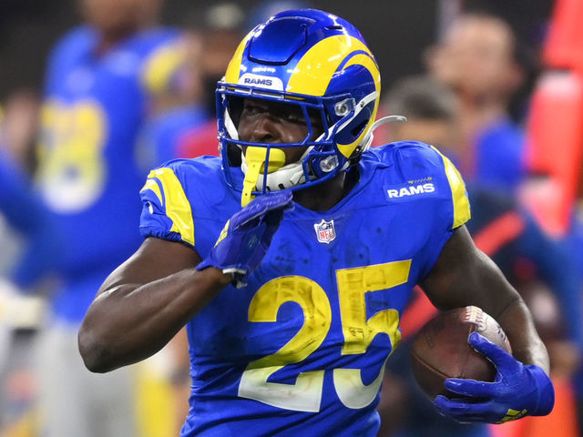 INGLEWOOD, CA - DECEMBER 21: Sony Michel #25 of the Los Angeles Rams avoids a tackle by Blessuan Austin #36 of the Seattle Seahawks as he runs for a first down in the game at SoFi Stadium on December 19, 2021 in Inglewood, California.