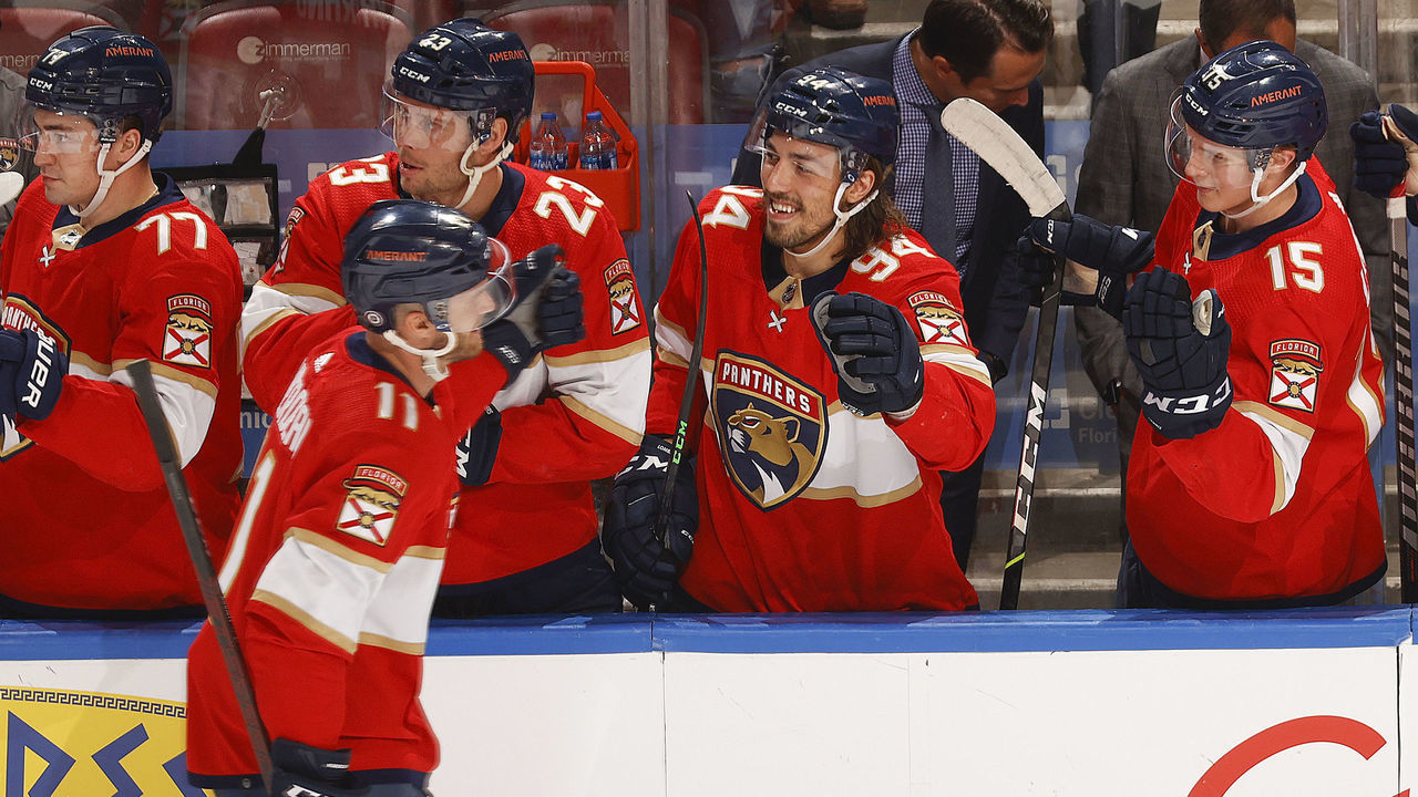 SUNRISE, FL - DECEMBER 30: Teammates congratulate Jonathan Huberdeau #11 of the Florida Panthers after he scored a first period goal against the Tampa Bay Lightning at the FLA Live Arena on December 30, 2021 in Sunrise, Florida.