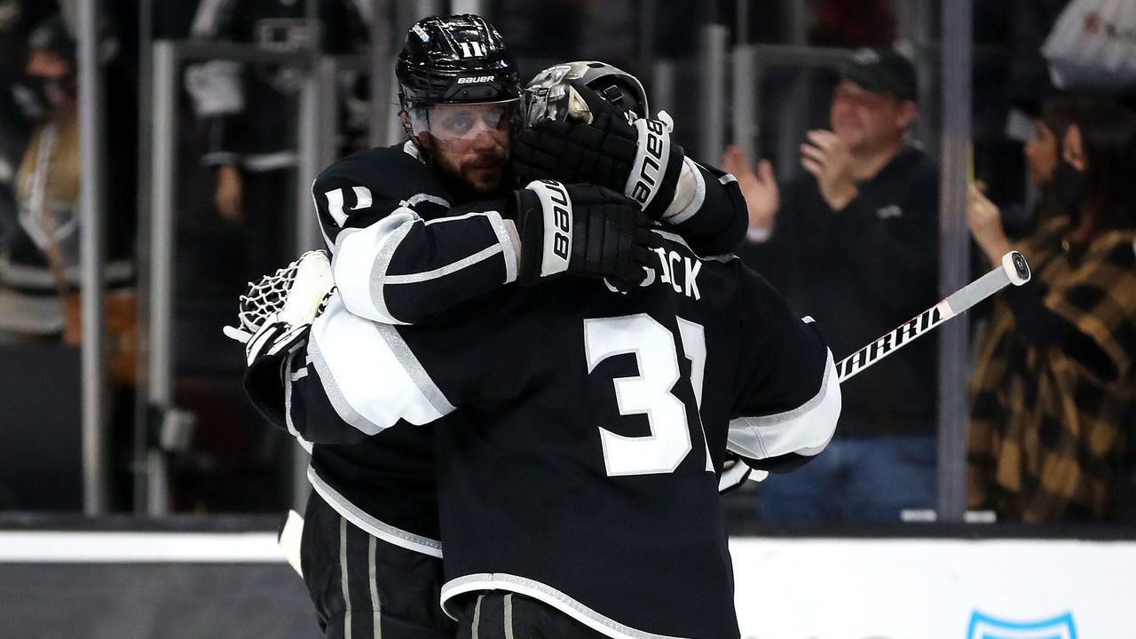 LOS ANGELES, CALIFORNIA - DECEMBER 30: Jonathan Quick #32 of the Los Angeles Kings celebrates his final save with teammate Anze Kopitar #11 after a shootout against the Vancouver Canucks at Crypto.com Arena on December 30, 2021 in Los Angeles, California.