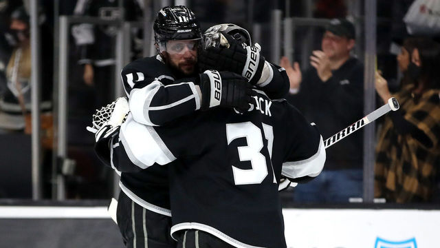 LOS ANGELES, CALIFORNIA - DECEMBER 30: Jonathan Quick #32 of the Los Angeles Kings celebrates his final save with teammate Anze Kopitar #11 after a shootout against the Vancouver Canucks at Crypto.com Arena on December 30, 2021 in Los Angeles, California.