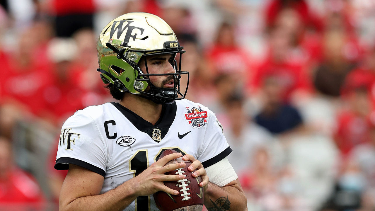 JACKSONVILLE, FLORIDA - DECEMBER 31: Sam Hartman #10 of the Wake Forest Demon Deacons looks to pass against the Rutgers Scarlet Knights during the TaxSlayer Gator Bowl at TIAA Bank Field on December 31, 2021 in Jacksonville, Florida.