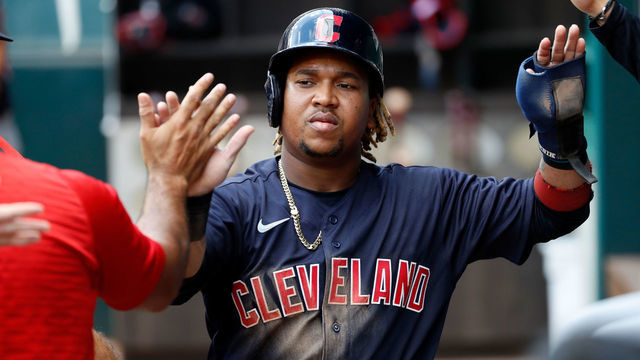 ARLINGTON, TEXAS - OCTOBER 03: Jose Ramirez #11 of the Cleveland Indians is greeted by teammates after scoring a run in the third inning against the Texas Rangers at Globe Life Field on October 03, 2021 in Arlington, Texas.