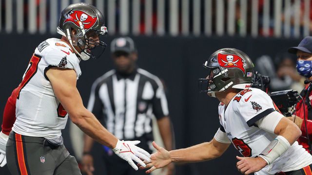 ATLANTA, GEORGIA - DECEMBER 05: Rob Gronkowski #87 of the Tampa Bay Buccaneers celebrates his touchdown against the Atlanta Falcons with teammate Tom Brady #12 during the second quarter at Mercedes-Benz Stadium on December 05, 2021 in Atlanta, Georgia.