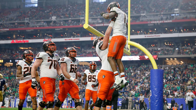 GLENDALE, ARIZONA - JANUARY 01: Tay Martin #1 of the Oklahoma State Cowboys celebrates with teammates after scoring a touchdown in the third quarter against the Notre Dame Fighting Irish during the PlayStation Fiesta Bowl at State Farm Stadium on January 01, 2022 in Glendale, Arizona.