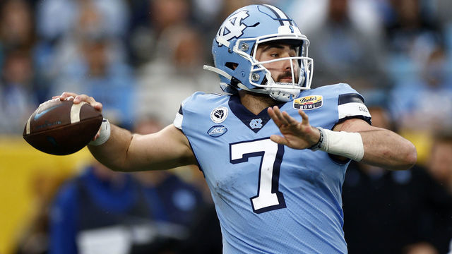 CHARLOTTE, NORTH CAROLINA - DECEMBER 30: Sam Howell #7 of the North Carolina Tar Heels looks to pass during the first half of the Duke's Mayo Bowl against the South Carolina Gamecocks at Bank of America Stadium on December 30, 2021 in Charlotte, North Carolina.