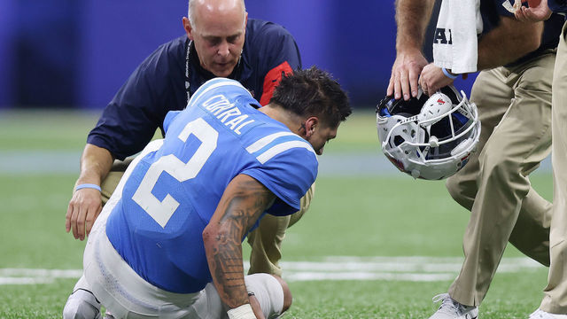 NEW ORLEANS, LOUISIANA - JANUARY 01: Matt Corral #2 of the Mississippi Rebels is looked over by a trainer after being injured against the Baylor Bears during the first quarter in the Allstate Sugar Bowl at Caesars Superdome on January 01, 2022 in New Orleans, Louisiana.