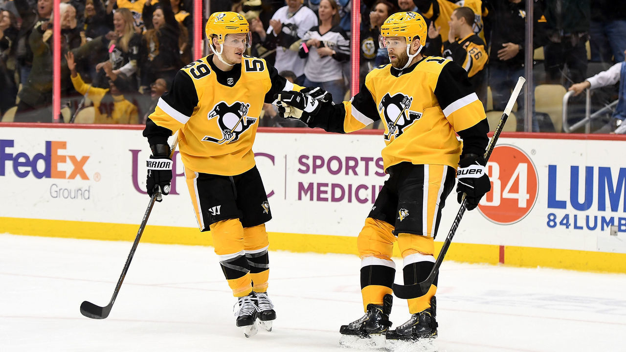PITTSBURGH, PA - DECEMBER 28: Bryan Rust #17 of the Pittsburgh Penguins celebrates with Jake Guentzel #59 after scoring an empty net goal in the third period during the game against the Nashville Predators at PPG Paints Arena on December 28, 2019 in Pittsburgh, Pennsylvania.