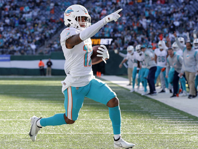 EAST RUTHERFORD, NEW JERSEY - NOVEMBER 21: (NEW YORK DAILIES OUT) Jaylen Waddle #17 of the Miami Dolphins runs in his touchdown against the New York Jets at MetLife Stadium on November 21, 2021 in East Rutherford, New Jersey. The Dolphins defeated the Jets 24-17.