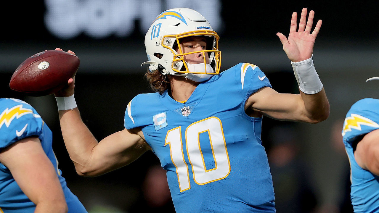 INGLEWOOD, CALIFORNIA - JANUARY 02: Justin Herbert #10 of the Los Angeles Chargers delivers a pass over the defense of the Denver Broncos in the first quarter of the game at SoFi Stadium on January 02, 2022 in Inglewood, California.