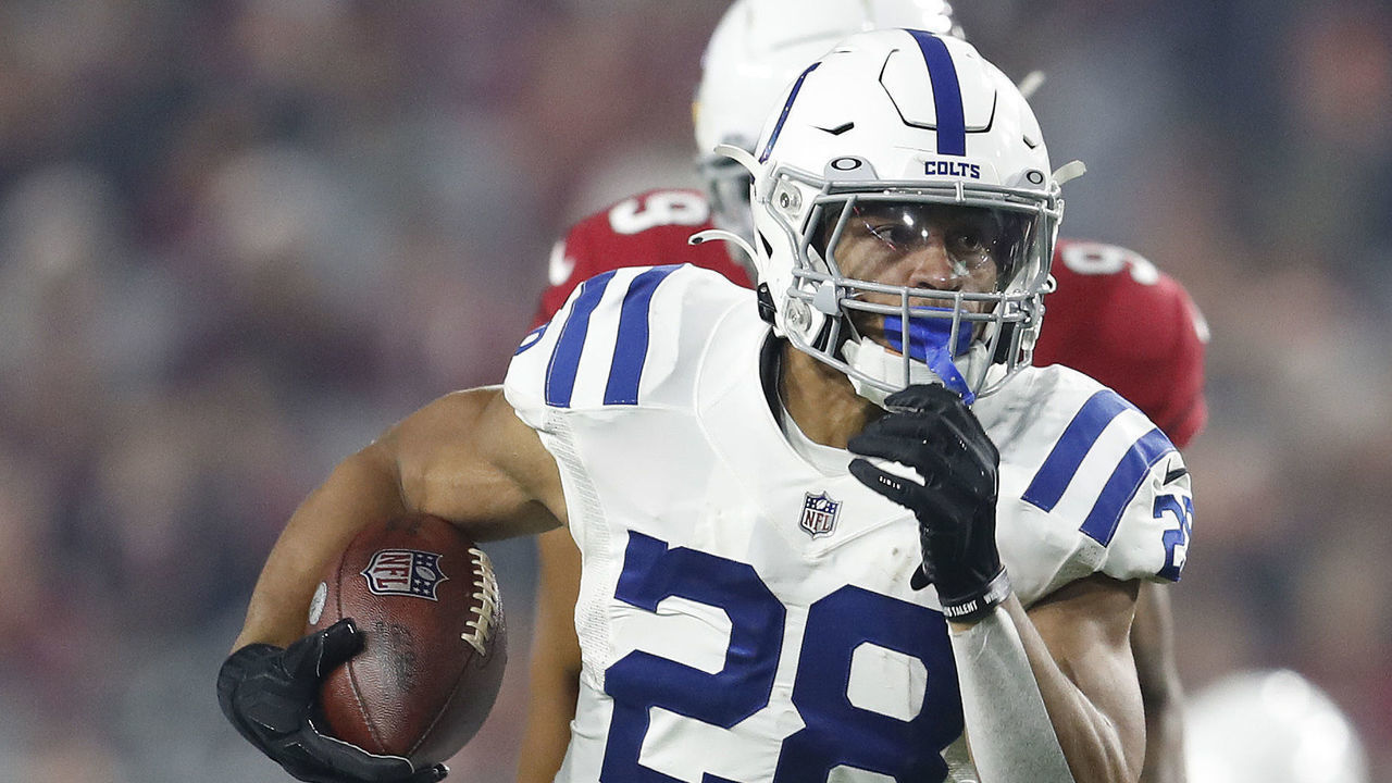 GLENDALE, ARIZONA - DECEMBER 25: Jonathan Taylor #28 of the Indianapolis Colts runs with the ball against the Arizona Cardinals during the first half at State Farm Stadium on December 25, 2021 in Glendale, Arizona.