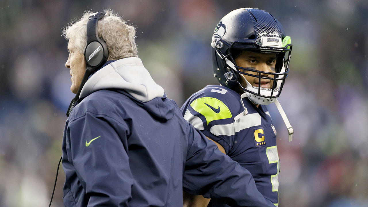 SEATTLE, WASHINGTON - JANUARY 02: Head coach Pete Carroll and Russell Wilson #3 of the Seattle Seahawks interact on the sidelines during the second half against the Detroit Lions at Lumen Field on January 02, 2022 in Seattle, Washington.