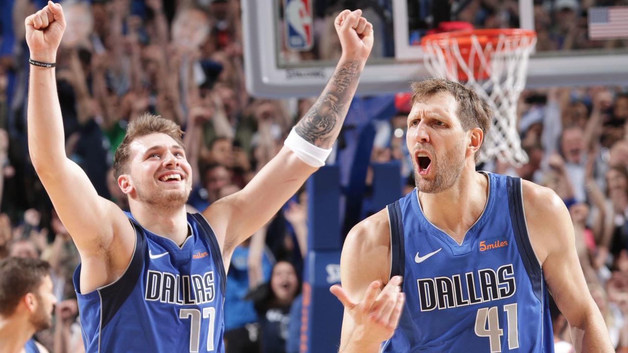 DALLAS, TX - APRIL 9: Luka Doncic #77 and Dirk Nowitzki #41 of the Dallas Mavericks celebrate a basket during the game against the Phoenix Suns on April 9, 2019 at the American Airlines Center in Dallas, Texas. Mandatory Copyright Notice: Copyright 2019 NBAE