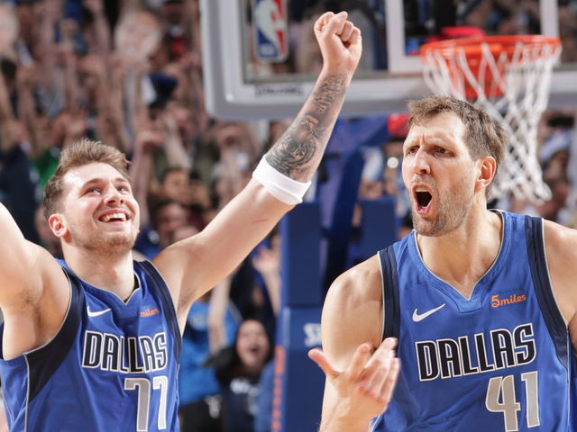DALLAS, TX - APRIL 9: Luka Doncic #77 and Dirk Nowitzki #41 of the Dallas Mavericks celebrate a basket during the game against the Phoenix Suns on April 9, 2019 at the American Airlines Center in Dallas, Texas. Mandatory Copyright Notice: Copyright 2019 NBAE