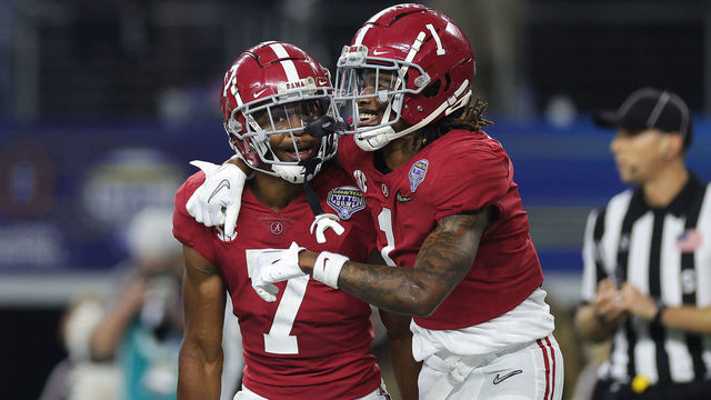 ARLINGTON, TEXAS - DECEMBER 31: Ja'Corey Brooks #7 of the Alabama Crimson Tide celebrates with Jameson Williams #1 of the Alabama Crimson Tide after scoring a touchdown against the Cincinnati Bearcats during the second quarter in the Goodyear Cotton Bowl Classic for the College Football Playoff semifinal game at AT&T Stadium on December 31, 2021 in Arlington, Texas.