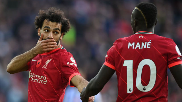 LIVERPOOL, ENGLAND - OCTOBER 30: Mohamed Salah of Liverpool talks with team mate Sadio Mane during the Premier League match between Liverpool and Brighton & Hove Albion at Anfield on October 30, 2021 in Liverpool, England.
