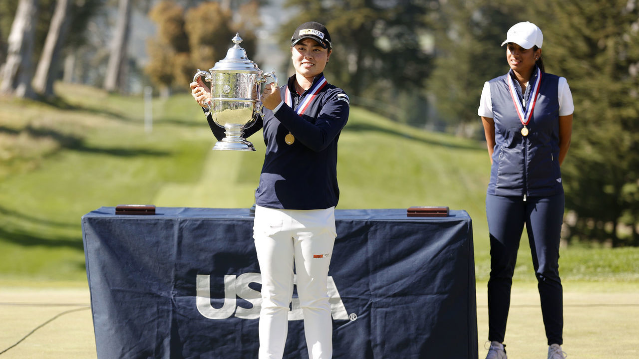 SAN FRANCISCO, CALIFORNIA - JUNE 06: Yuka Saso of the Philippines celebrates with the Harton S. Semple Trophy as Megha Ganne of the United States, the low amateur of the tournament, looks on following the 76th U.S. Women's Open Championship at The Olympic Club on June 06, 2021 in San Francisco, California. Saso won following a three-hole playoff against Nasa Hataoka of Japan.