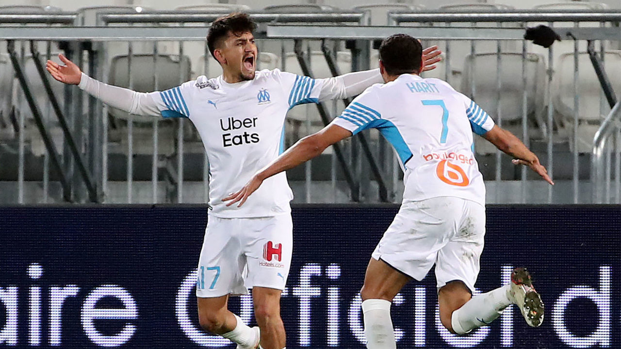 Marseille's Turkish forward Cengiz Under (L) celebrates with Marseille's French midfielder Amine Harit after scoring a goal during the French L1 football match between Girondins de Bordeaux and Olympique de Marseille (OM) at the Matmut stadium in Bordeaux, southwestern France, on January 7, 2022.