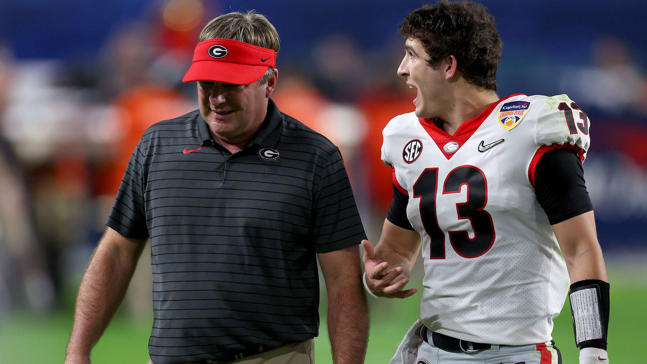 MIAMI GARDENS, FLORIDA - DECEMBER 31: Stetson Bennett #13 talks with Head Coach Kirby Smart of the Georgia Bulldogs as they walk off the field at halftime in the Capital One Orange Bowl for the College Football Playoff semifinal game at Hard Rock Stadium on December 31, 2021 in Miami Gardens, Florida.