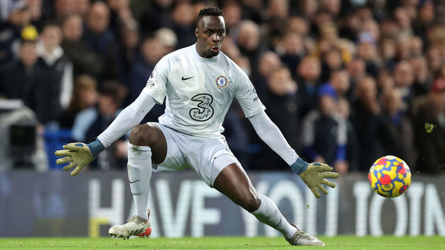 LONDON, ENGLAND - JANUARY 02: Chelsea goalkeeper Edouard Mendy spreads his body to successfully save a shot from Mohamed Salah of Liverpool during the Premier League match between Chelsea and Liverpool at Stamford Bridge on January 2, 2022 in London, England.