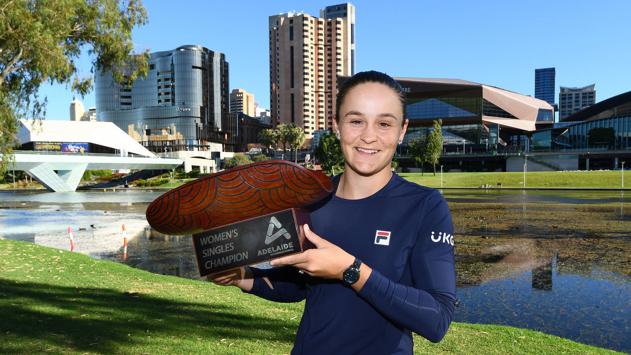 ADELAIDE, AUSTRALIA - JANUARY 09: Ashleigh Barty of Australia holds the Womens Singles Champion trophy after defeating Elena Rybakina of Kazakhstan at Pinky Flat on the River Torrens during day eight of the 2022 Adelaide International at Memorial Drive on January 09, 2022 in Adelaide, Australia.