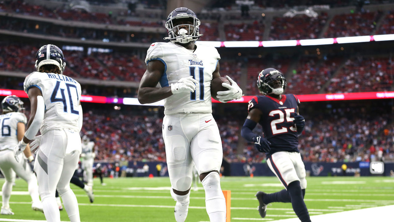 HOUSTON, TEXAS - JANUARY 09: A.J. Brown #11 of the Tennessee Titans catches the ball for a touchdown during the second quarter against the Houston Texans at NRG Stadium on January 09, 2022 in Houston, Texas.