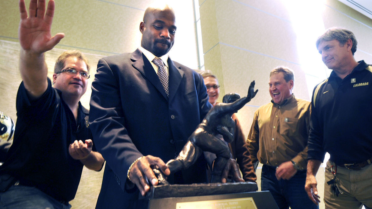 Former CU Buff and Heisman Trophy winner Rashaan Salaam stands in front of his trophy before taking group pictures during the University of Colorado Football Preview Luncheon on Thursday, Feb. 3, at the Hyatt Regency Denver Convention Center in Denver.