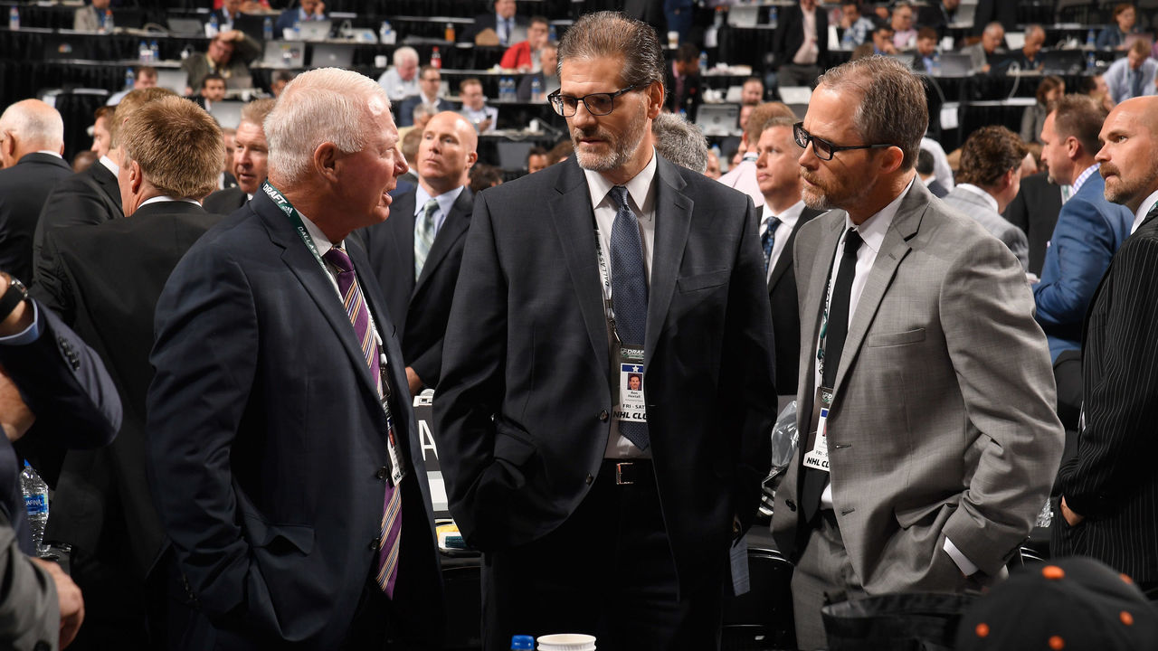 DALLAS, TX - JUNE 22: (L-R) SVP Bobby Clarke, general manager Ron Hextall and assistant general manager Chris Pryor of the Philadelphia Flyers talk on the draft floor during the first round of the 2018 NHL Draft at American Airlines Center on June 22, 2018 in Dallas, Texas.