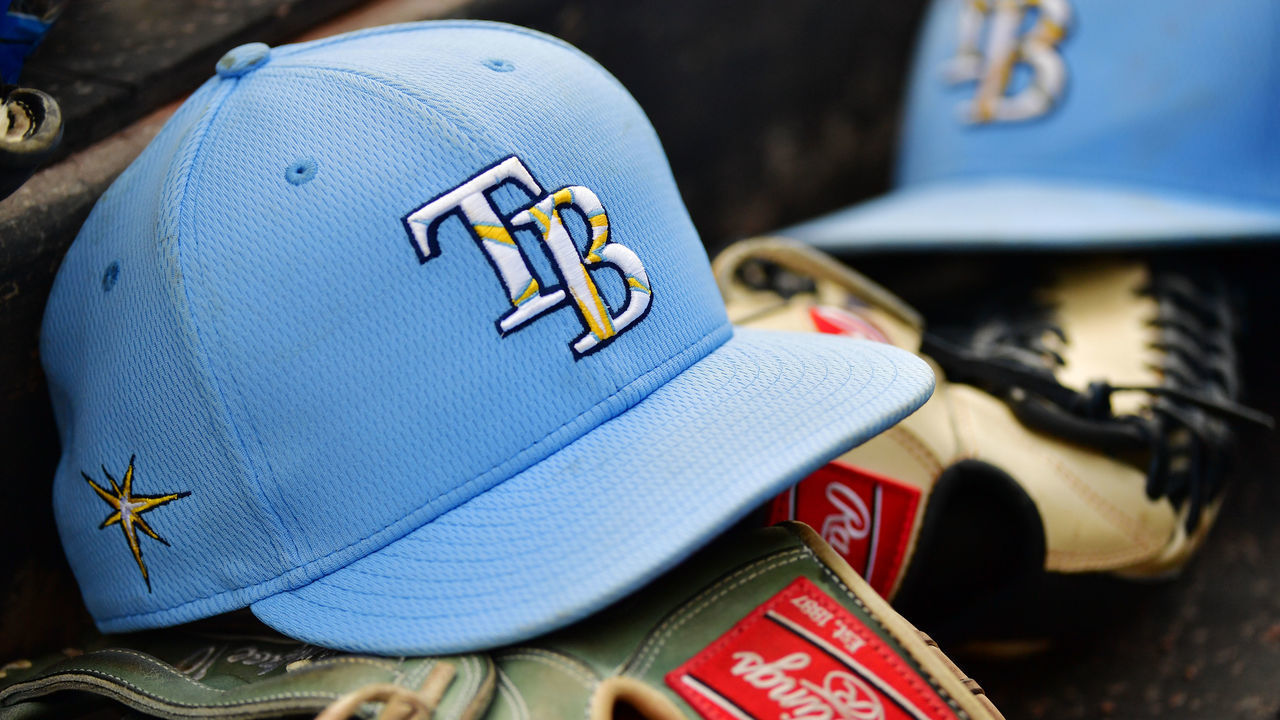 SARASOTA, FLORIDA - MARCH 02: A Tampa Bay Rays hat sits on top of a glove in the dugout during a Grapefruit League spring training game between the Baltimore Orioles and the Tampa Bay Rays at Ed Smith Stadium on March 02, 2020 in Sarasota, Florida.