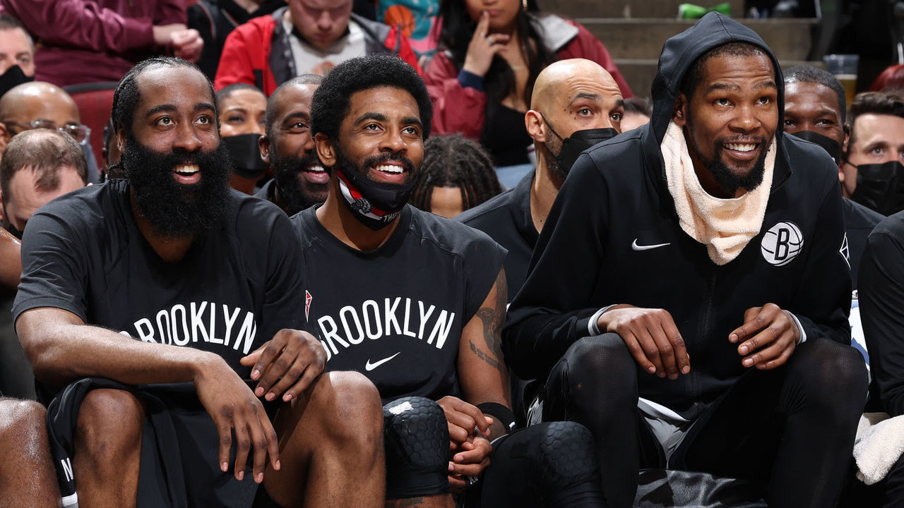 CHICAGO, IL - JANUARY 12: James Harden #13, Kyrie Irving #11 and Kevin Durant #7 of the Brooklyn Nets smiles on the bench during the game against the Chicago Bulls on January 12, 2022 at United Center in Chicago, Illinois. Mandatory Copyright Notice: Copyright 2022 NBAE