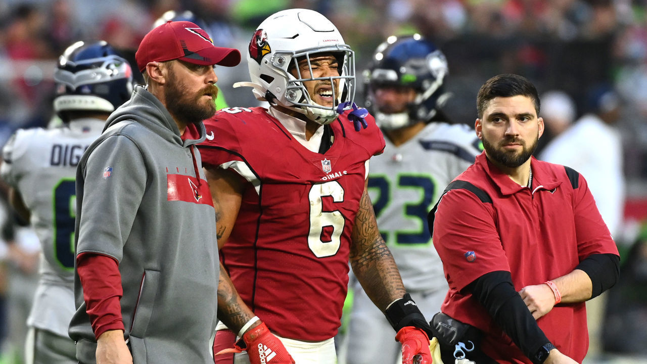GLENDALE, ARIZONA - JANUARY 09: James Conner #6 of the Arizona Cardinals reacts as he is helped off the field after being injured on a play during the fourth quarter against the Seattle Seahawks at State Farm Stadium on January 09, 2022 in Glendale, Arizona.