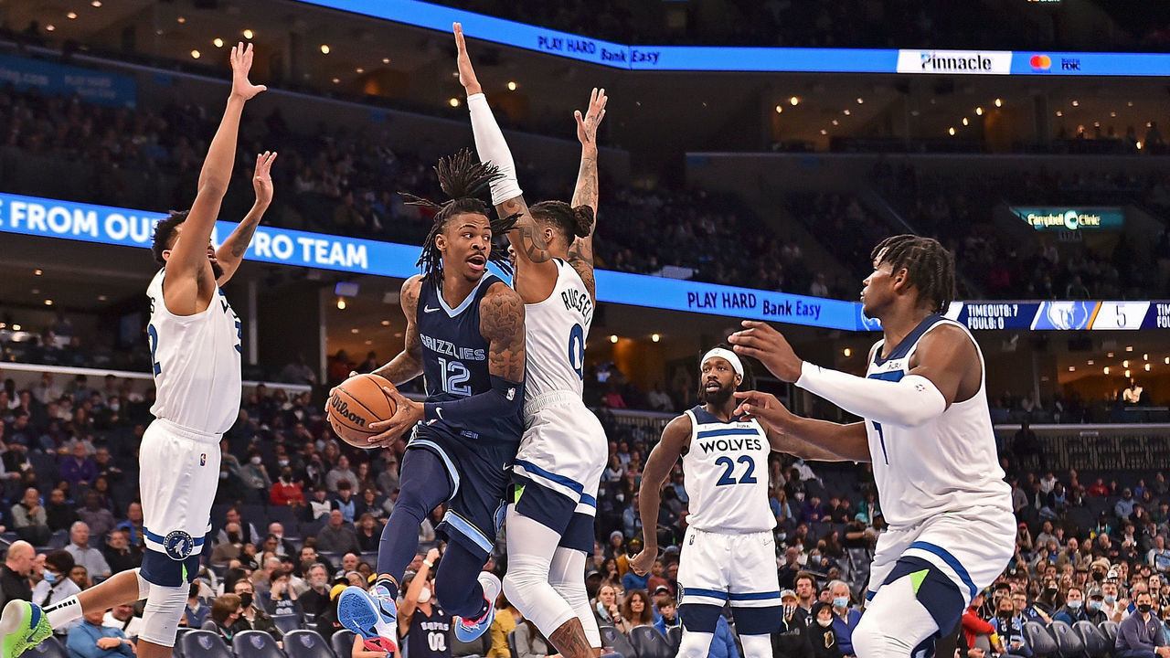 MEMPHIS, TENNESSEE - JANUARY 13: Ja Morant #12 of the Memphis Grizzlies looks to pass against the Minnesota Timberwolves during the first half at FedExForum on January 13, 2022 in Memphis, Tennessee.