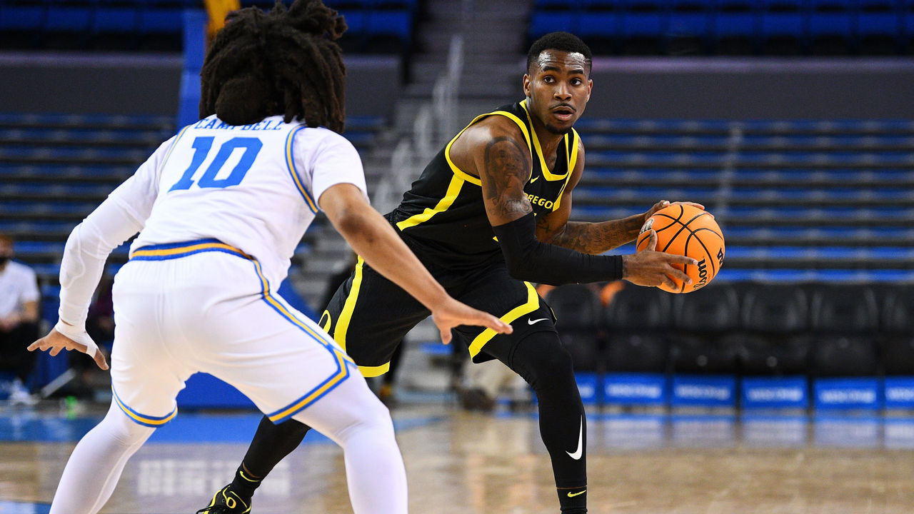 LOS ANGELES, CA - JANUARY 13: Oregon Ducks guard De'Vion Harmon (5) tries to pass around UCLA Bruins guard Tyger Campbell (10) during a college basketball game between the Oregon Ducks and the UCLA Bruins on January 13, 2022, at Pauley Pavilion in Los Angeles, CA.