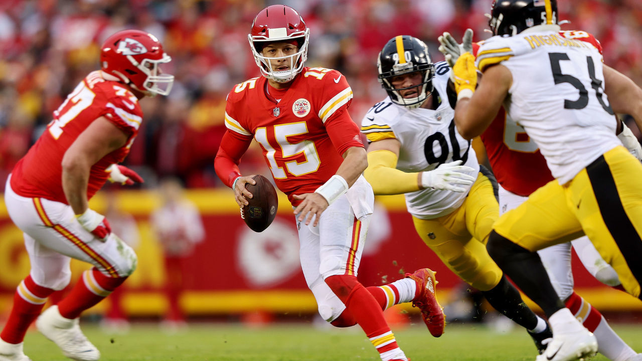 KANSAS CITY, MISSOURI - DECEMBER 26: Patrick Mahomes #15 of the Kansas City Chiefs is chased by T.J. Watt #90 and Alex Highsmith #56 of the Pittsburgh Steelers during the second quarter at Arrowhead Stadium on December 26, 2021 in Kansas City, Missouri.