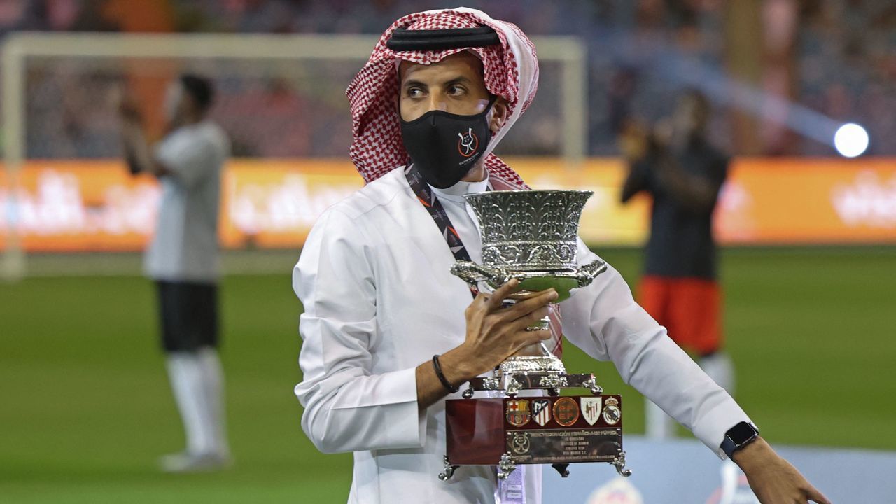 A staff member holds the trophy ahead of the Spanish Super Cup semi-final football match between Barcelona and Real Madrid at the King Fahd International stadium in the Saudi capital Riyadh on January 12, 2022.