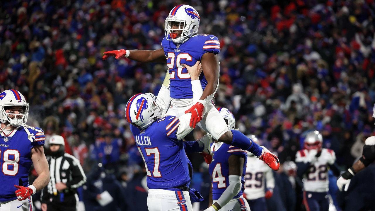 Orchard Park, NY - January 15: Buffalo Bills quarterback Josh Allen (17) lifts up Buffalo Bills running back Devin Singletary (26) after his rushing touchdown in the second quarter. The Buffalo Bills host the New England Patriots in a AFC wild-card game Saturday night January 15, 2022 at Highmark Stadium in Orchard Park, NY.