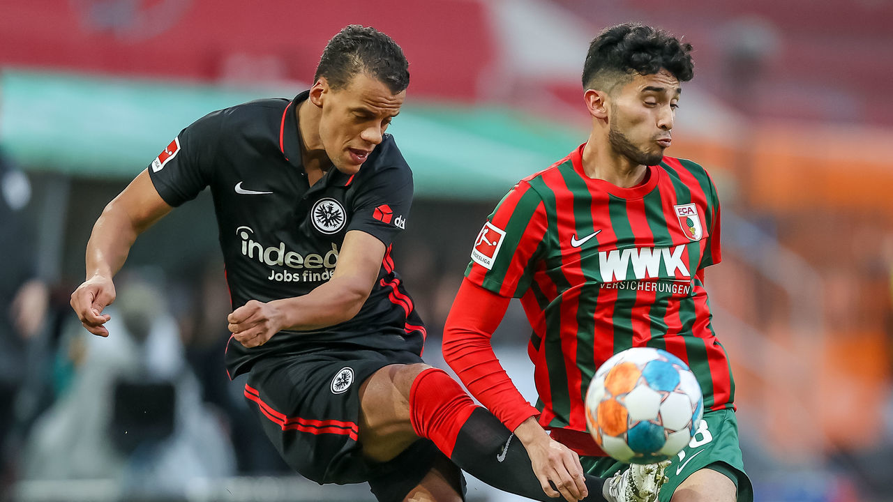 AUGSBURG, GERMANY - JANUARY 16: Timothy Chandler of Eintracht Frankfurt and Ricardo Pepi of FC Augsburg battle for the ball during the Bundesliga match between FC Augsburg and Eintracht Frankfurt at WWK-Arena on January 16, 2022 in Augsburg, Germany.
