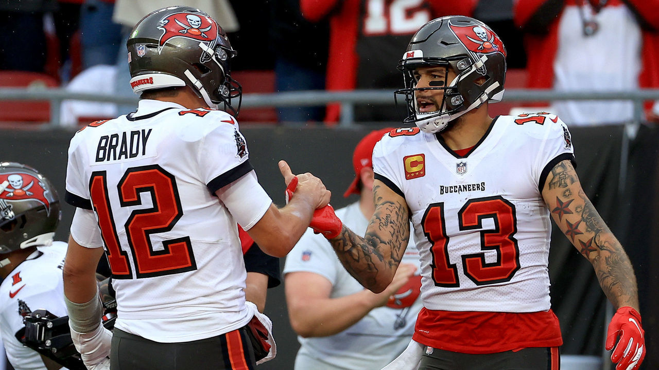 TAMPA, FLORIDA - JANUARY 16: Mike Evans #13 of the Tampa Bay Buccaneers celebrates with Tom Brady #12 after scoring a touchdown against the Philadelphia Eagles during the third quarter in the NFC Wild Card Playoff game at Raymond James Stadium on January 16, 2022 in Tampa, Florida.
