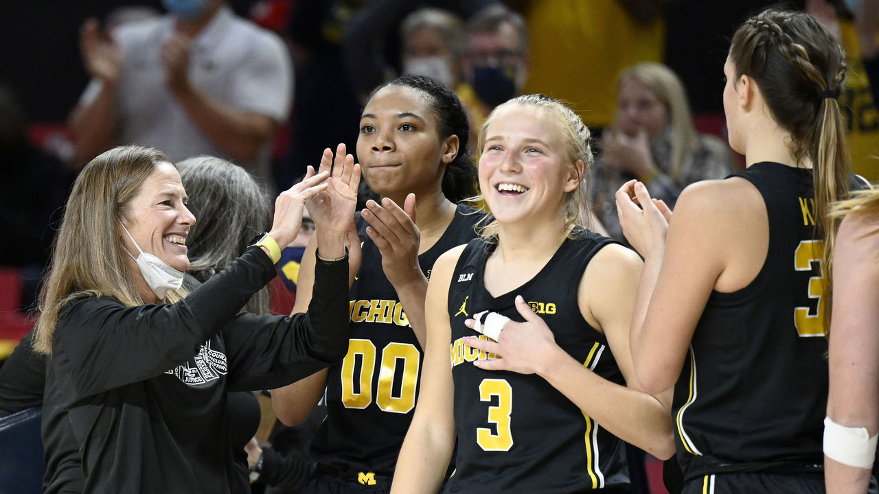 COLLEGE PARK, MARYLAND - JANUARY 16: Head Coach Kim Barnes Arico of the Michigan Wolverines celebrates with Naz Hillmon #0 and Maddie Nolan #3 after a victory against the Maryland Terrapins at Xfinity Center on January 16, 2022 in College Park, Maryland.
