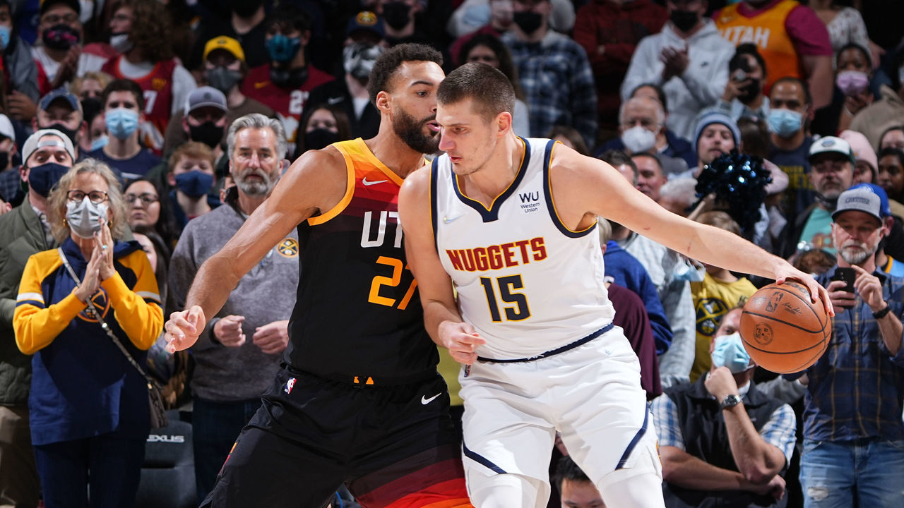 DENVER, CO - JANUARY 16: Nikola Jokic #15 of the Denver Nuggets handles the ball as Rudy Gobert #27 of the Utah Jazz plays defense during the game on January 16, 2022 at the Ball Arena in Denver, Colorado. NOTE TO USER: User expressly acknowledges and agrees that, by downloading and/or using this Photograph, user is consenting to the terms and conditions of the Getty Images License Agreement. Mandatory Copyright Notice: Copyright 2022 NBAE