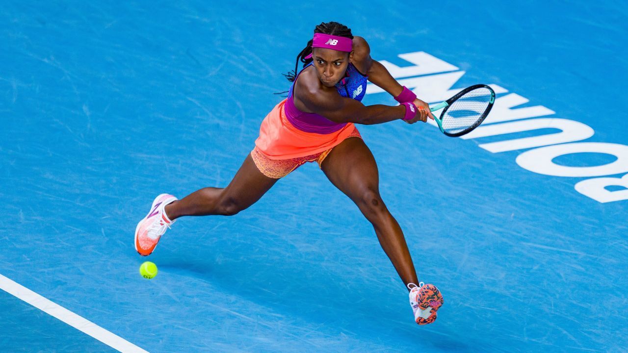 MELBOURNE, AUSTRALIA - JANUARY 17: Coco Gauff of United States lunges to play a backhand in her first round singles match against Qiang Wang of China during day one of the 2022 Australian Open at Melbourne Park on January 17, 2022 in Melbourne, Australia.