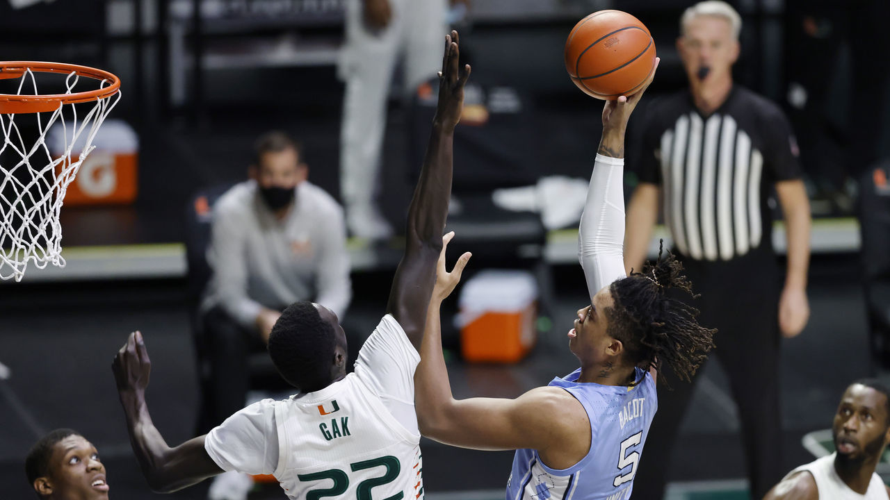 MIAMI, FLORIDA - JANUARY 05: Armando Bacot #5 of the North Carolina Tar Heels shoots over Deng Gak #22 of the Miami Hurricanes during the first half at Watsco Center on January 05, 2021 in Miami, Florida.